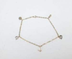 Gold bracelet with small charms.
