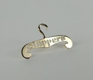 Gold hanger pin with "clappers" text.