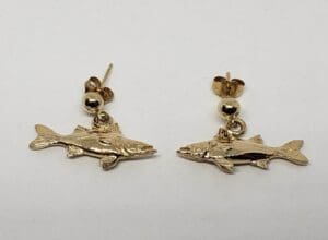 Gold fish-shaped earrings on white background.
