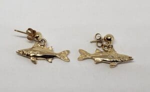Gold fish-shaped earrings on white background.