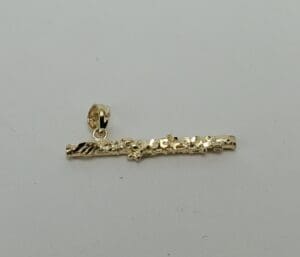 Gold textured pendant on white background.