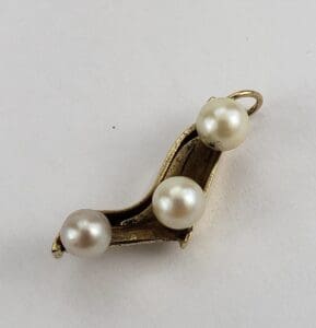 Gold pendant with three white pearls.