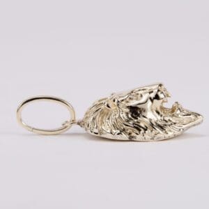 Gold lion head keychain on display.