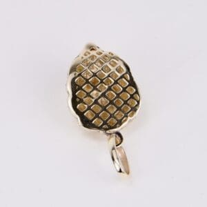 Gold pendant with textured grid pattern.