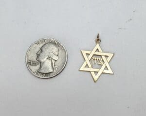 Quarter and Star of David pendant comparison.
