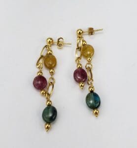 Gold earrings with colorful gemstone beads.