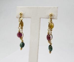 Gold earrings with colorful gemstone beads.