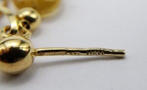Close-up of gold jewelry with engravings.