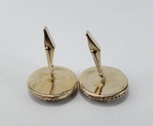 Gold cufflinks with round base.