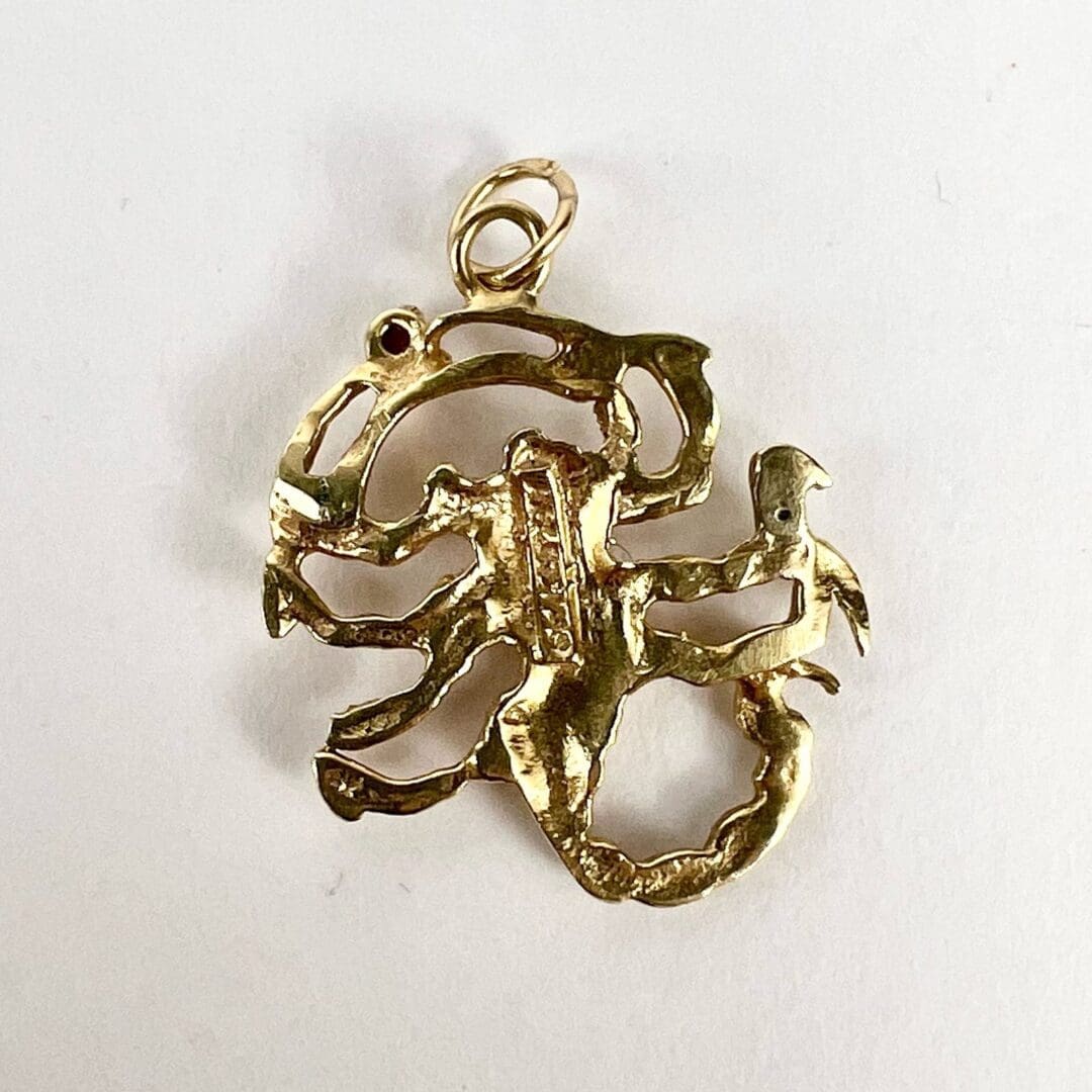 Gold Scorpio zodiac pendant on white background.