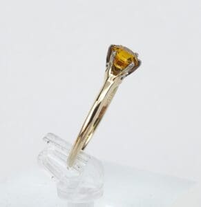 Gold ring with a yellow gemstone.