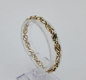 Gold bracelet with intricate chain design.