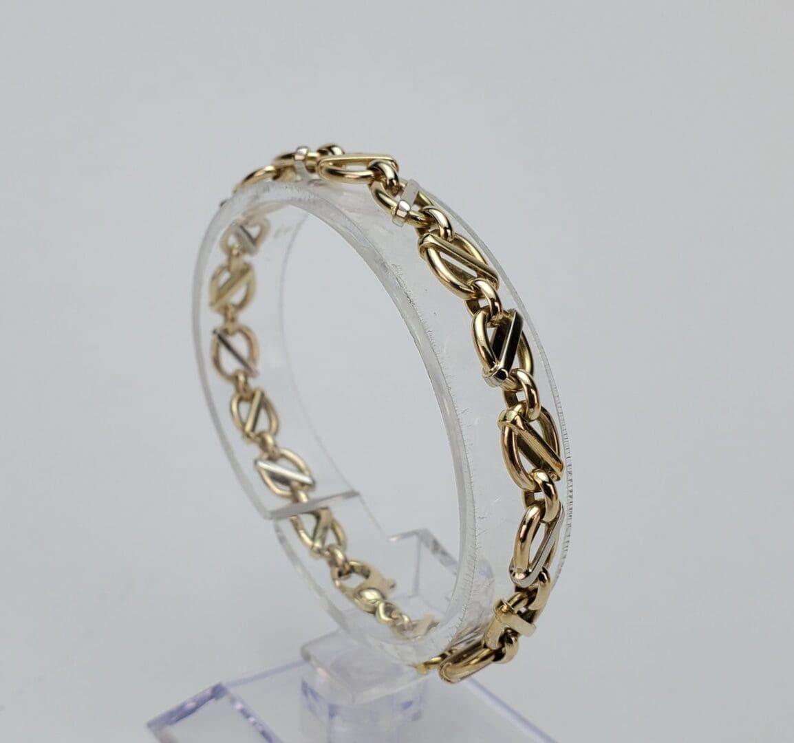 Gold bracelet with intricate chain design.