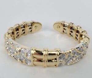 Gold and silver ornate bracelet on display.