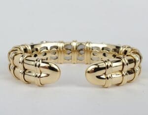 Gold bracelet with intricate design details.