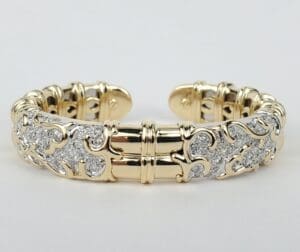 Gold and silver ornate bracelet on display.