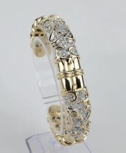 Gold and silver ornate bracelet on display.
