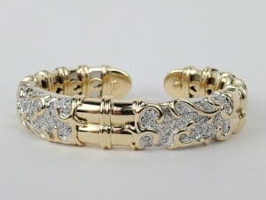 Ornate gold and silver bracelet with diamonds.