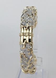 Gold and diamond ornate bracelet display.
