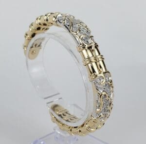Gold and silver ornate bangle bracelet.