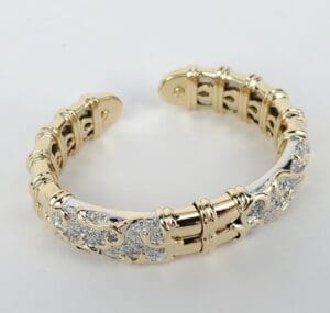 Gold and silver ornate bracelet on display.