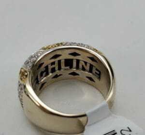 Gold and silver ring with engraved text.