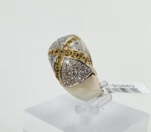 Gold and silver ring with diamonds displayed.
