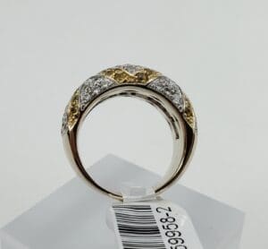 Gold and silver diamond ring on display.