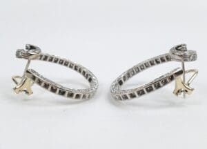 Silver earrings with gold accents displayed.