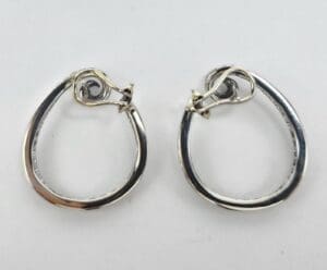 Silver hoop earrings with latch closure.