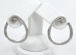 Silver spiral earrings with diamond accents.