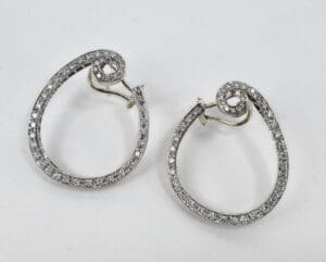 Silver spiral earrings with embedded stones.