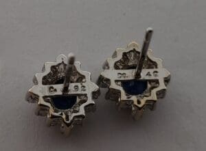 Back view of silver earrings with stones.