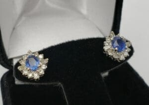 Blue gemstone earrings in a jewelry box.