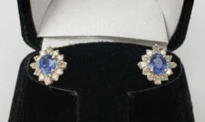 Blue gemstone earrings in black jewelry box.