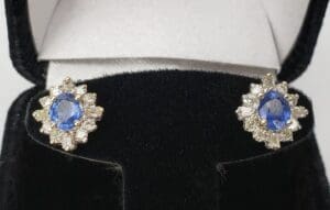 Blue gemstone earrings in black velvet box.