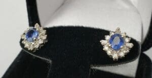 Blue gemstone earrings in black velvet box.