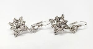Silver floral earrings with sparkling stones.