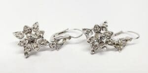 Silver floral earrings with crystal accents.