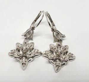 Silver star-shaped earrings with gemstone accents.