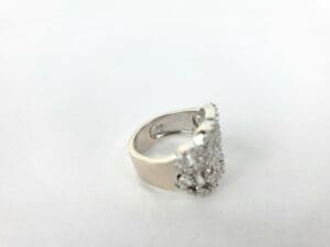 Silver ring with diamond cluster setting.