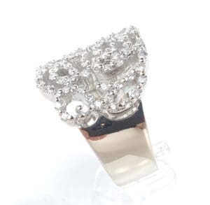 Intricate diamond ring on white background.