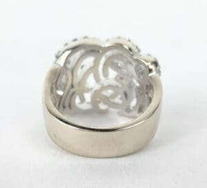 Silver ring with intricate cut-out design.