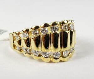 Gold ring with diamonds on white background.