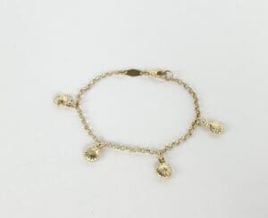 Gold bracelet with shell charms.