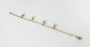 Gold bracelet with shell charms.