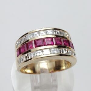 Gold ring with red and white stones.