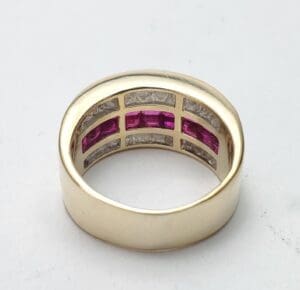 Gold ring with pink and clear stones.