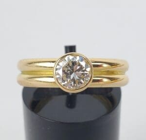 Gold ring with a large diamond centerpiece.