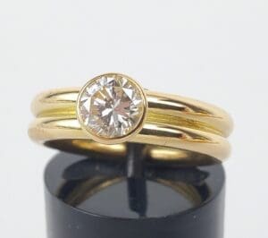 Gold ring with round diamond setting.